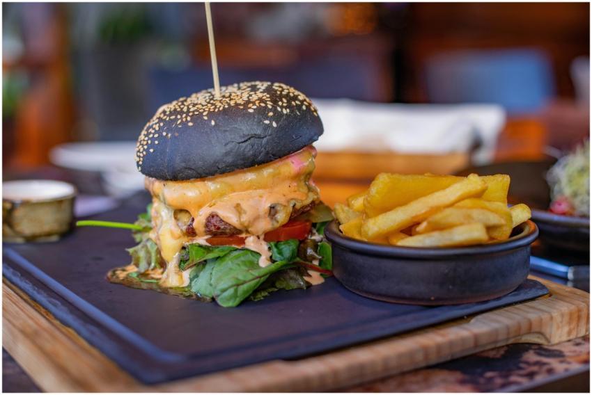 Mouthwatering black bun cheeseburger and crispy fr