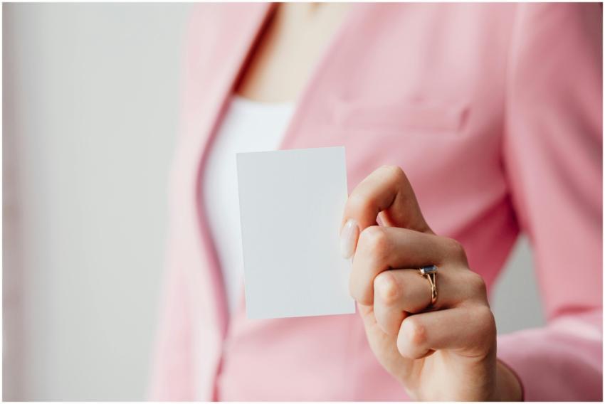 Close-up of a woman's hand holding a blank busines