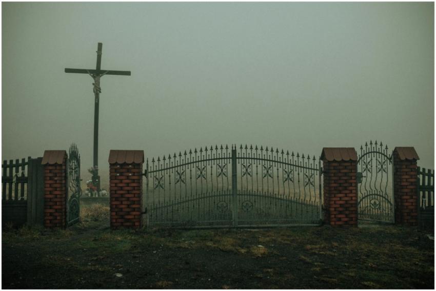 A mysterious foggy atmosphere surrounds a crucifix