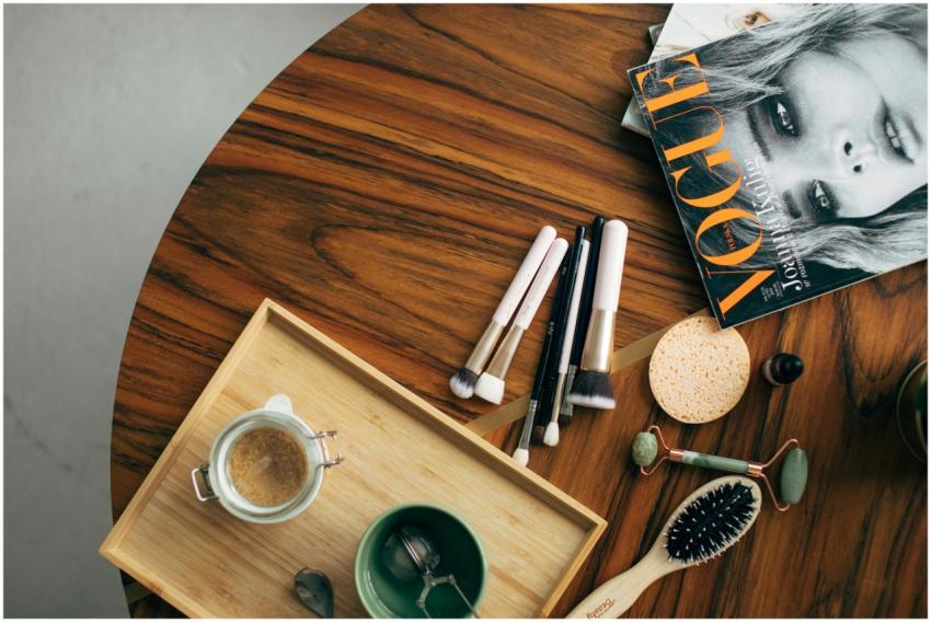 Stylish flatlay featuring makeup brushes, a Vogue