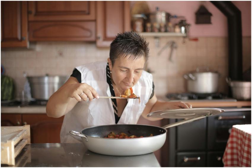 A woman savoring the aroma of a freshly cooked dis
