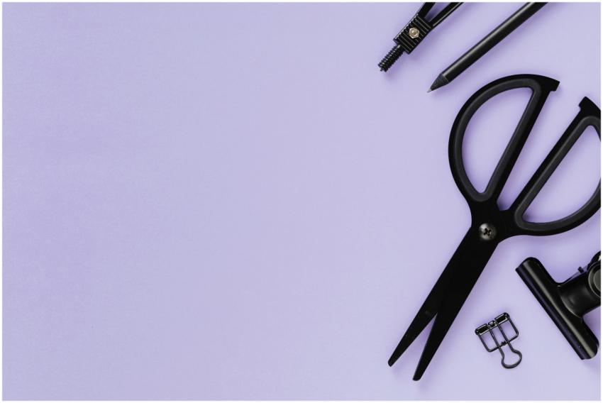 Flat lay of black school supplies on a purple back