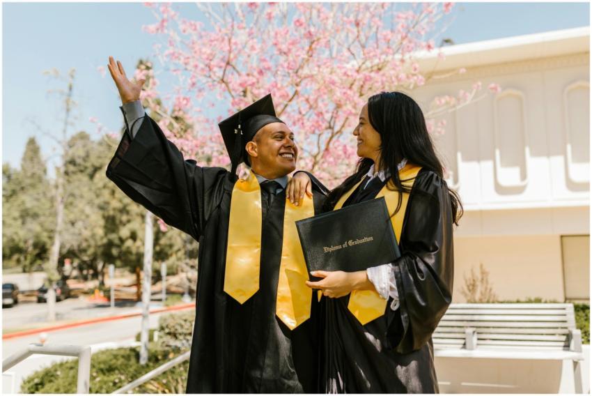 Two students celebrating graduation with caps and