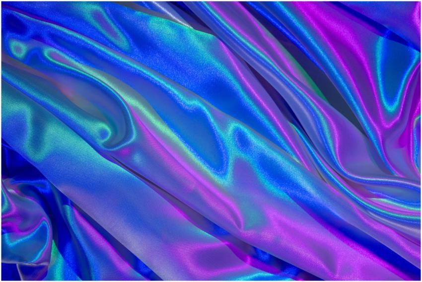 A close-up of vibrant satin fabric in hues of blue