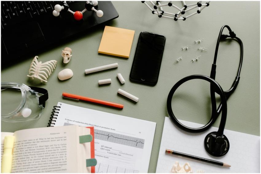 Flat lay of medical study desk with a stethoscope,