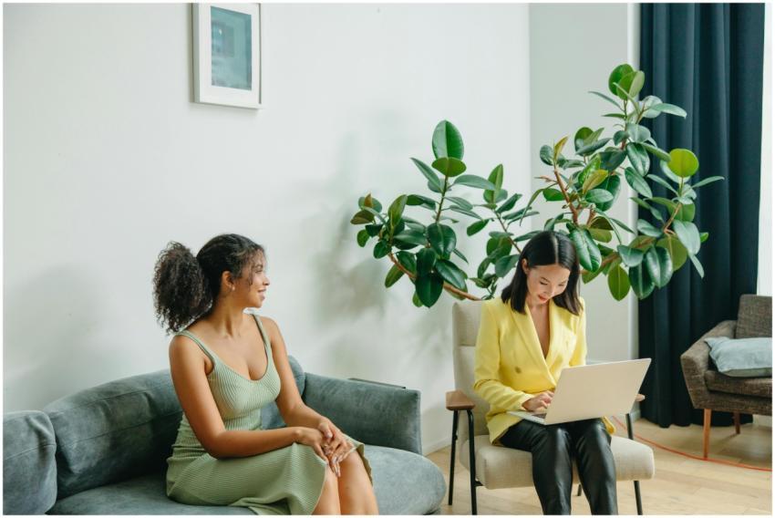 Two women engaged in a friendly consultation on a