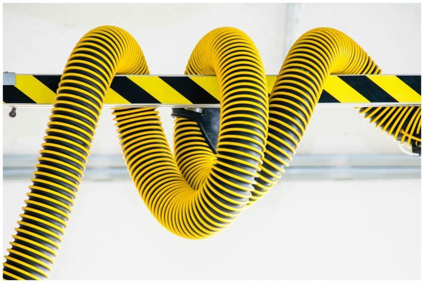 Close-up of yellow industrial hoses coiled around
