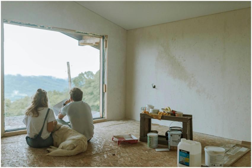 A couple with their dog resting in a partially ren