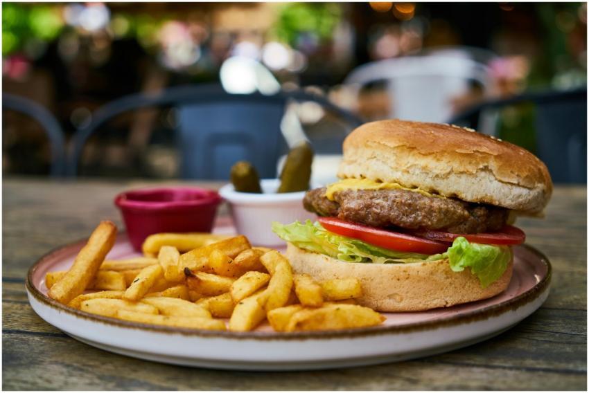 Mouth-watering cheeseburger with fries, pickles, a