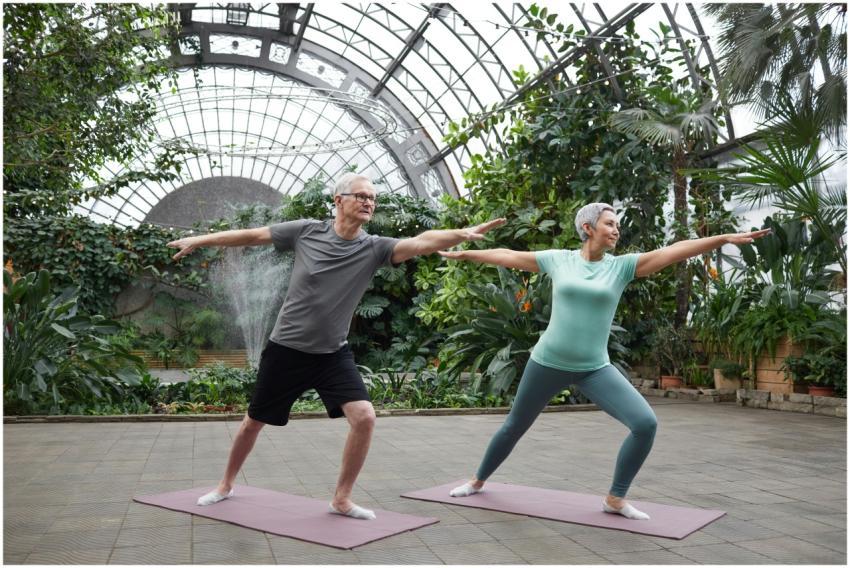 Elderly couple enjoying yoga exercises together in