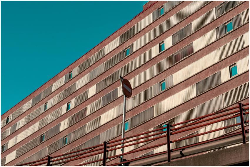 Futuristic urban building facade with striking red