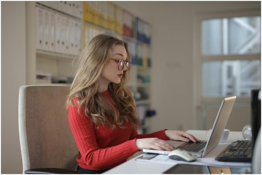 A dedicated female freelancer working on a laptop