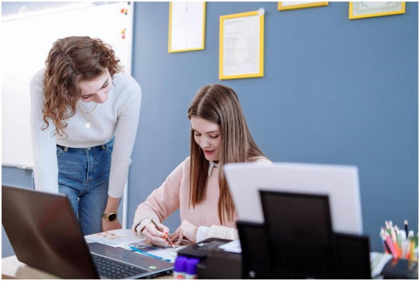 Two women working together on educational material