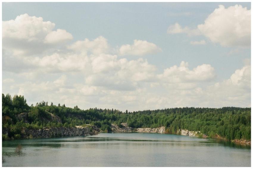Tranquil Karelian lake surrounded by lush forest u