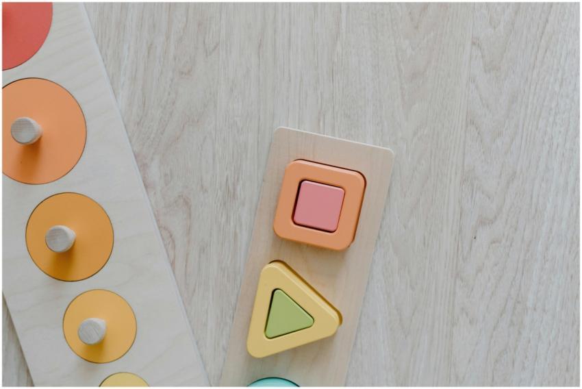 Top view of a wooden kids toy puzzle with colorful