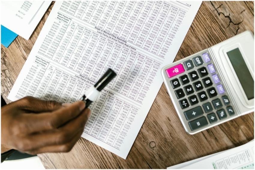 Close-up of tax documents and calculator on wooden
