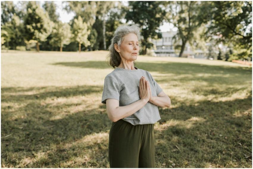 Elderly woman meditating and practicing yoga in a