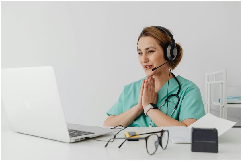 Female nurse using telemedicine for a virtual cons