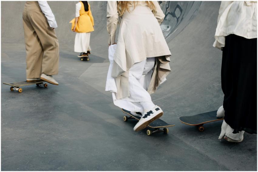 A group of individuals skateboarding in a skate pa