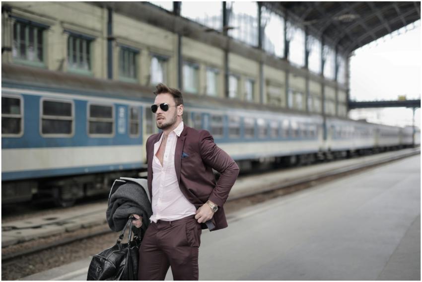 Stylish man in a suit waiting at a platform, embod