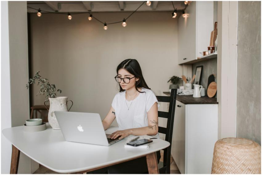 Young woman using a laptop in a stylish home offic