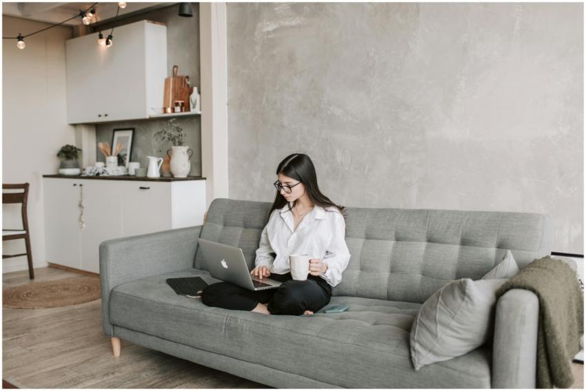 Woman in a modern living room working on a laptop