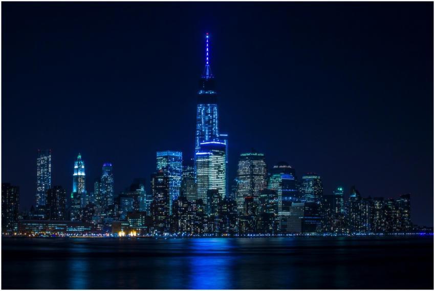 Illuminated New York City skyline reflecting over