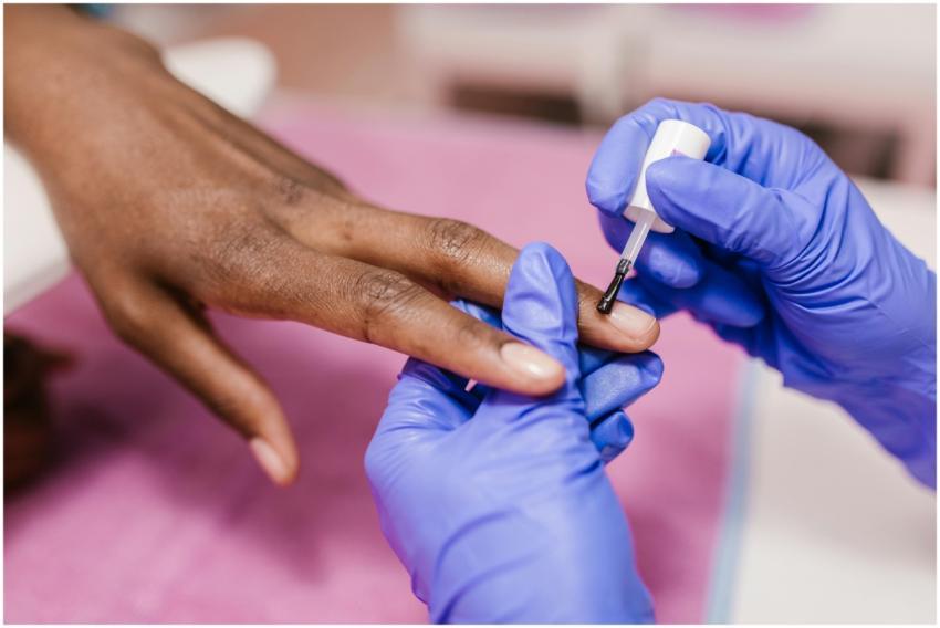 A close-up of a manicure in progress, featuring na