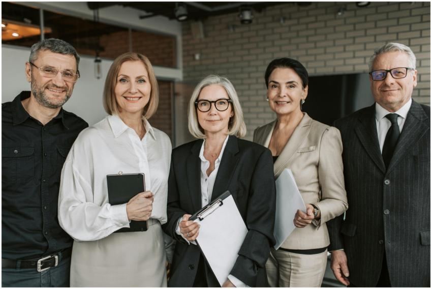 A diverse team of senior business professionals po