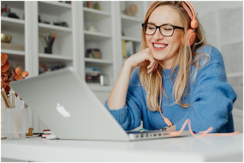 Smiling woman wearing headphones and glasses, work