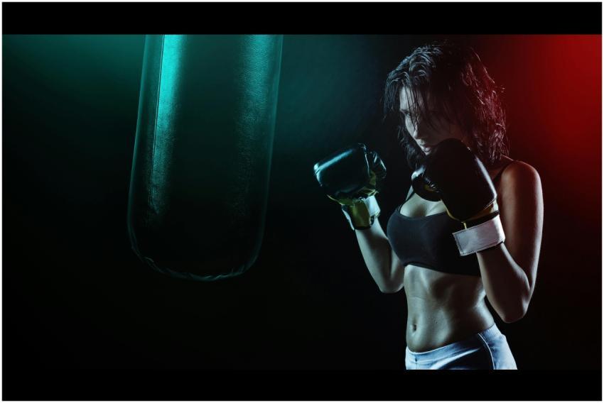 Powerful image of a woman boxer preparing to train