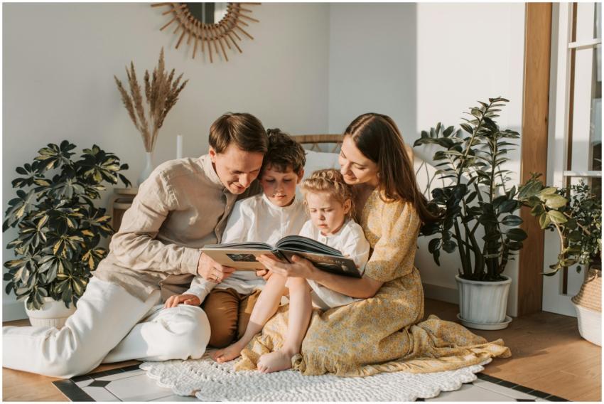 A joyful family shares a book indoors, surrounded