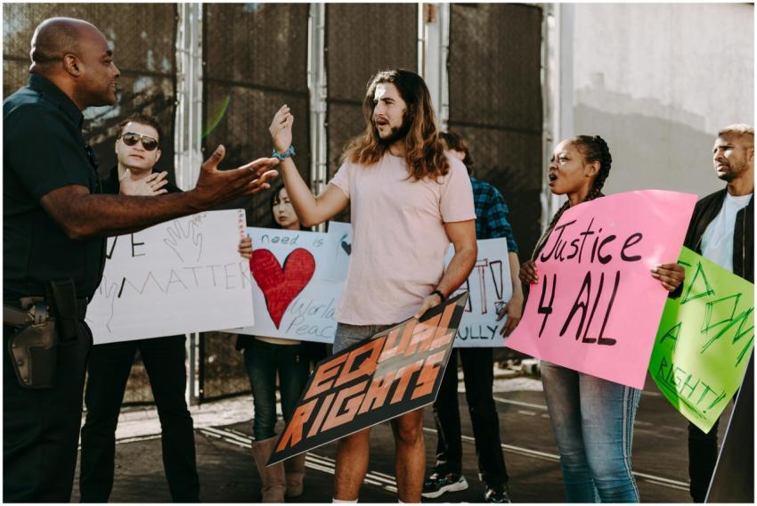 Diverse group of activists holding signs engaging