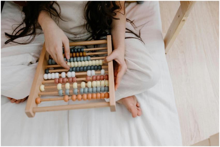 A child using a colorful abacus to learn math in a