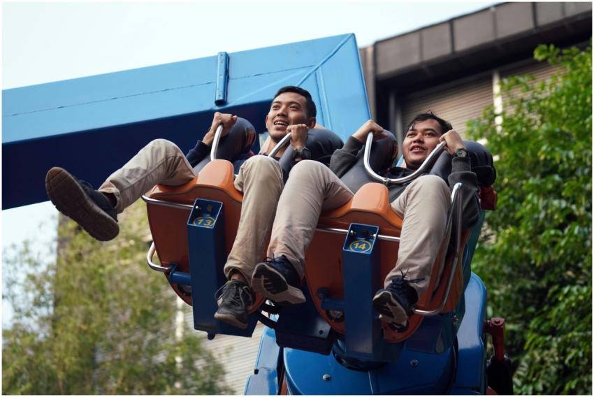 Excited Men Riding Amusement