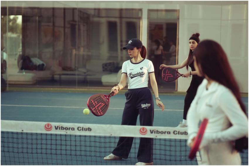 Women enjoying a padel match indoors at Vibora Clu