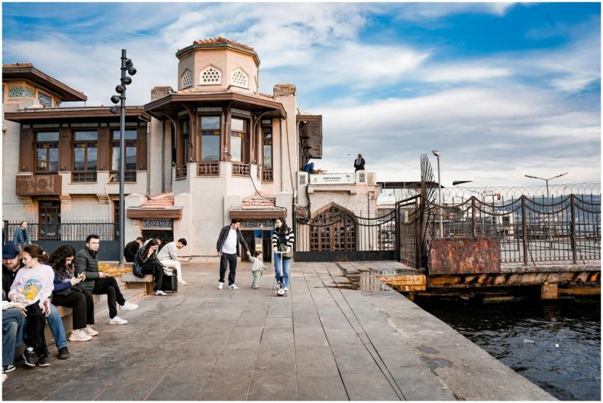 People enjoying a sunny day by the waterfront with
