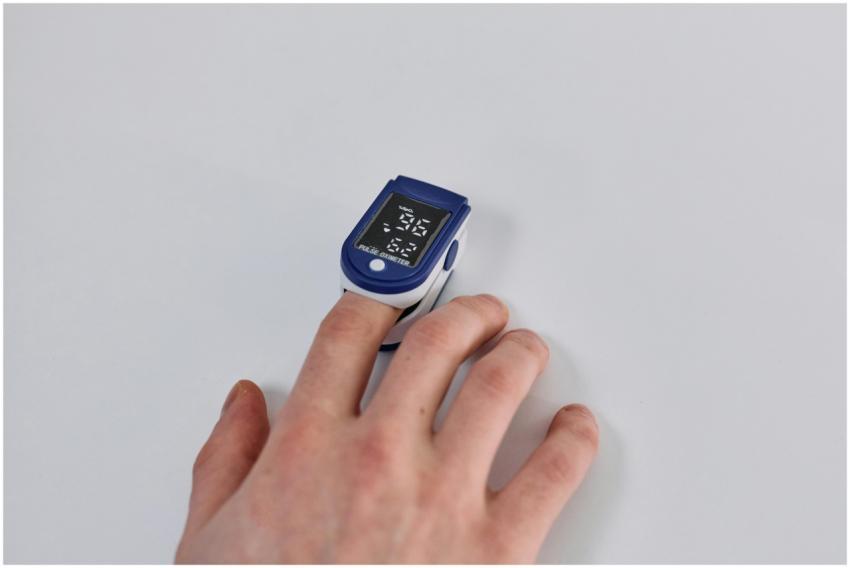 Close-up of a hand using a pulse oximeter to measu