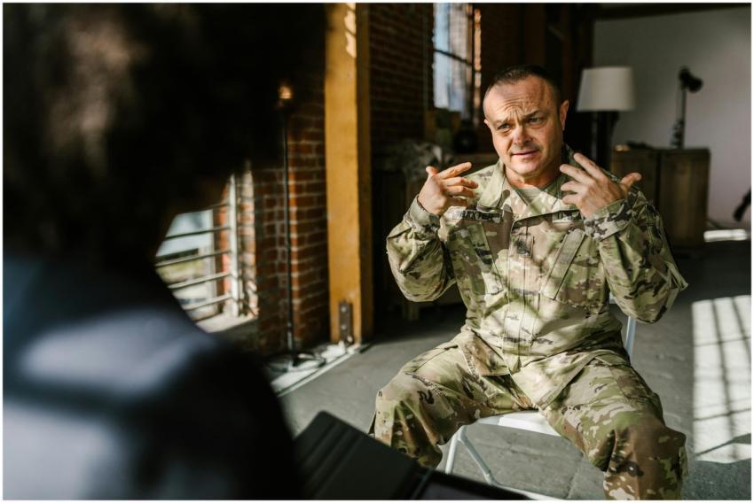 A combat veteran in military uniform engages in a