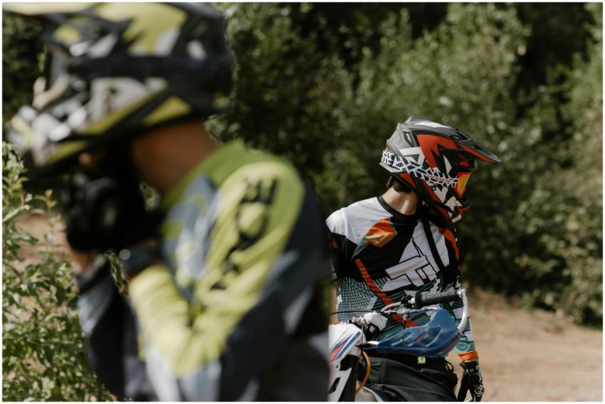 Two motorcyclists in protective gear and helmets r