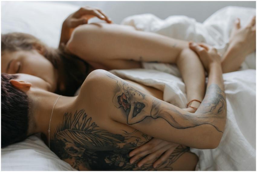 Two adults sharing a tender moment in a cozy bedro