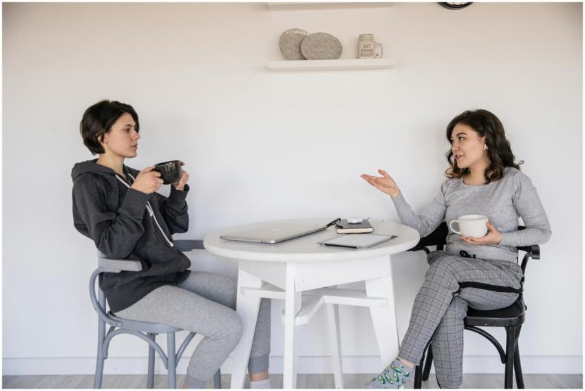 Two women enjoying a casual conversation with coff
