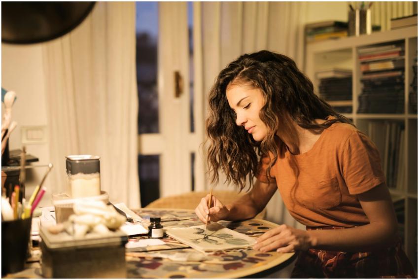 A young woman artist concentrating on a painting p