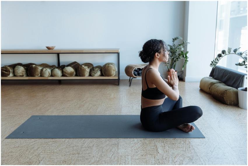 An African American woman meditating in a yoga stu