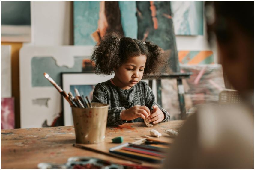 A child engaged in sculpting with plasticine at an