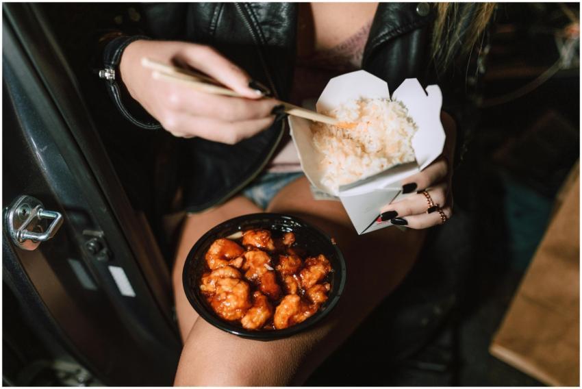 A woman enjoys delicious chicken teriyaki and rice