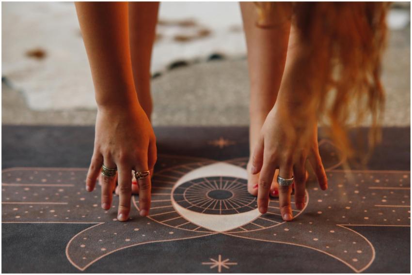 Detailed view of hands with rings in yoga pose on