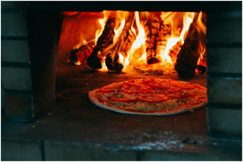 Close-up of a pizza baking in a traditional wood-f