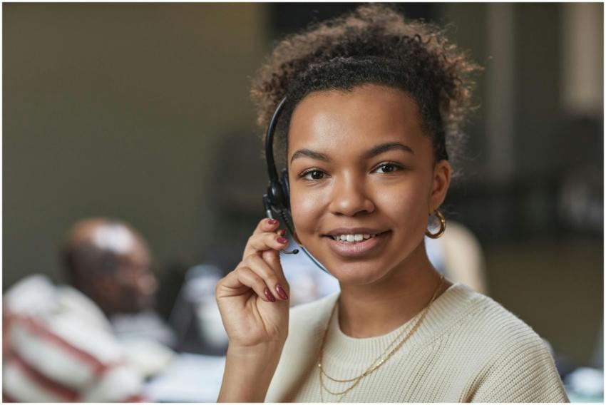 Friendly woman in a call center environment, weari
