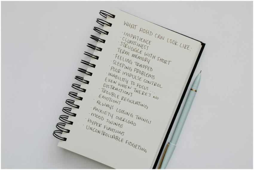 Notebook open with handwritten list of ADHD sympto